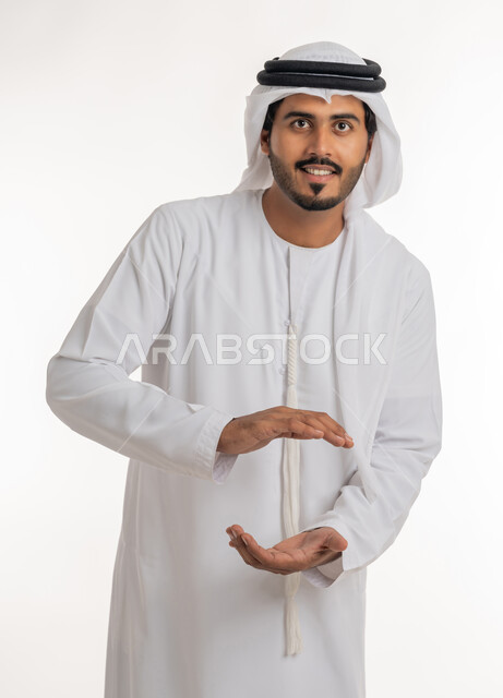 The concept of elegance and attention to external appearance, containing and holding an item, a close-up portrait of an Arab Gulf Emirati man wearing a kandora and turban, opening his hands to display three-dimensional holographic elements, white background.