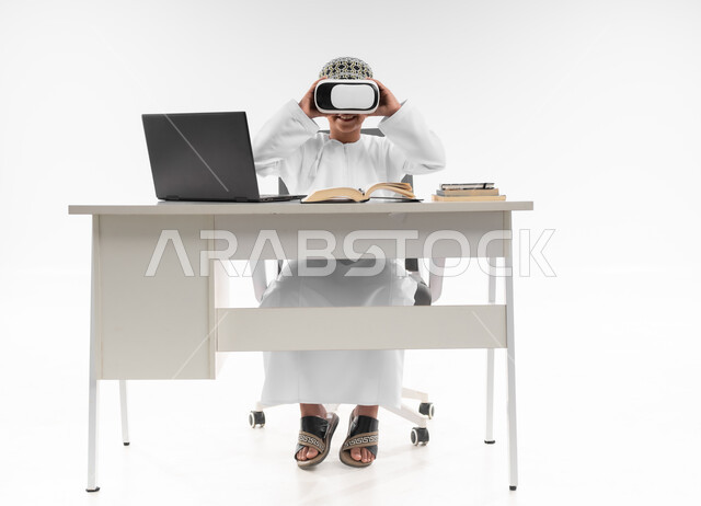 Combining learning with entertainment using modern technology, following new educational methods, advanced schools and academies, interacting with the virtual world, portrait of an Arab Gulf Omani boy wearing a dishdasha and a thobe, wearing VR glasses, full body image, white background
