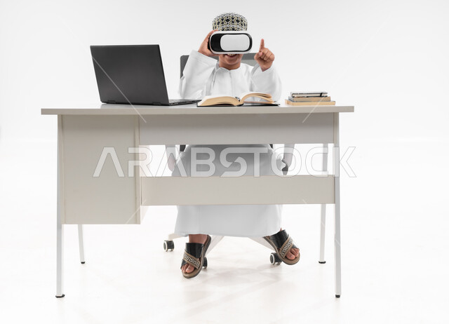 Combining learning with entertainment using modern technology, interacting with the virtual world, advanced schools and academies, following new educational methods, portrait of an Arab Gulf Omani boy wearing a dishdasha and a turban, wearing VR glasses, pointing at something, full body image, white background