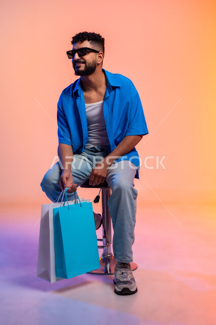 The concept of fitness and agility, maintaining physical balance, having a healthy athletic body, caring about appearance and elegance, portrait of a young Saudi Arabian Gulf man wearing casual clothes and sunglasses, gestures of self-confidence, full body length, colored background