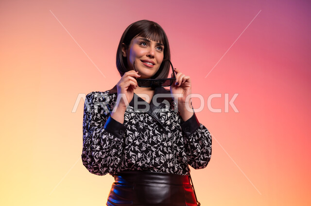 ايماءات الثقة بالنفس، ملامح الانوثة والنعومة, ألبسة خليجية نسائية عصرية، بورتريه مقرب لامرأة عربية خليجية سعودية ترتدي قميص منقط باللون الابيض والاسود، مفهوم الموضة والأناقة، عرض الأزياء والموديلات الحديثة، شراء الملابس والاكسسوارات الجديدة، خلفية ملونة