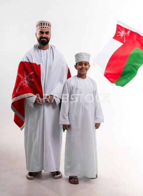 Celebrating Oman National Day, national flags and banners of Arab countries, pride in Omani symbols and banner, portrait of an Arab Gulf Omani boy and young man wearing a dishdasha and a kuma, the concept of love of the homeland and belonging to it, full body, white background