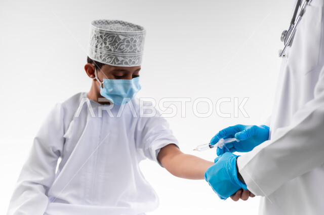 Following the Ministry of Health regulations, making it possible for children to receive the Corona virus vaccination, close-up portrait of a doctor wearing a medical coat and gloves, giving a dose of the Covid-19 vaccine to an Arab Gulf Omani child, adhering to safety procedures, full-length body, white background