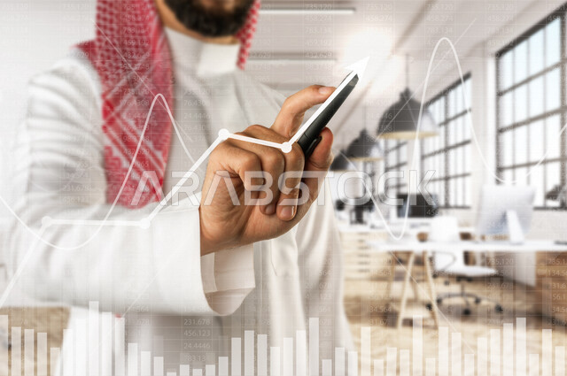 صورة مقربة ليد رجل عربي خليجي سعودي في مقرعمله بالشركة ، يمسك بقلمه و يقوم بالتحديد على شاشة البورصة  بتقنية الهولوجرام ثلاثية الأبعاد ، أمور مالية و حسابية ، باستخدام تقنية الهولوجرام ، ثلاثية الابعاد .