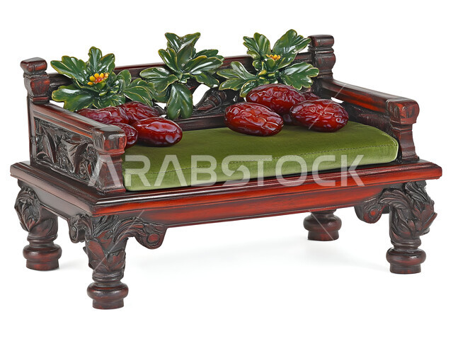 A bunch of curly braided dates on a green upholstered bench, local national products in Saudi Arabia, healthy and high-value meals, delicious Ramadan hospitality, different types of delicious dates