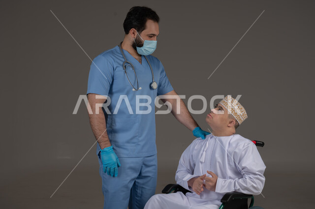طبيب يشرف على علاج شخص من ذوي الإحتياجات الخاصة والهمم, مفهوم تقديم المساعدة والدعم والعلاج, بورتريه لشاب عربي خليجي عماني يرتدي الكمه والدشداشة يجلس على كرسي متحرك, خلفية رمادي