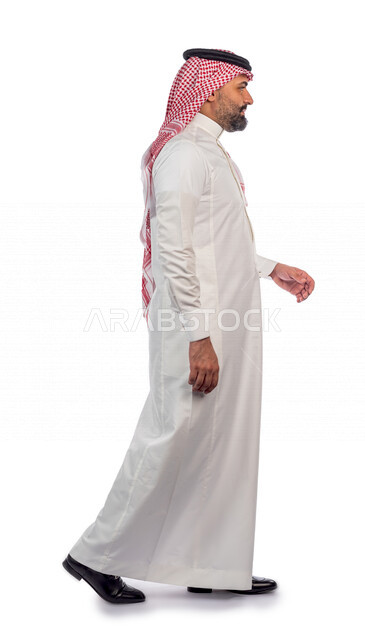 Portrait of a Saudi Gulf man doing a photo session with different face and hand gestures, side view of a Saudi Muslim man wearing traditional Saudi costume with shemagh and agal, white background