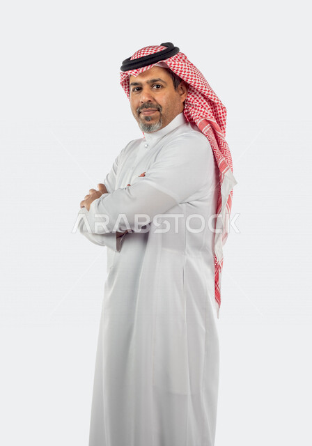 Portrait of a Saudi Gulf man doing a photo session with different face and hand gestures, side view of a Saudi Muslim man wearing traditional Saudi costume with shemagh and agal, white background