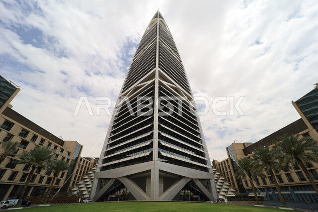 الاهتمام بزراعة أشجار النخيل في المدن، النمو والتطور العمراني في العاصمة، صورة من الاسفل لبرج الفيصلية في مدينة الرياض، الفن الهندسي المعماري للأبراج وناطحات السحاب في المملكة العربية السعودية، معالم ومباني مشهورة، منظر السماء المليئة بالغيوم البيضاء