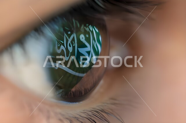 مفهوم حب الوطن والاعتزاز بالدولة, صورة مقربة لعين شاب عربي خليجي سعودي معكوس عليها علم المملكة العربية السعودية, الفخر بالراية الوطنية