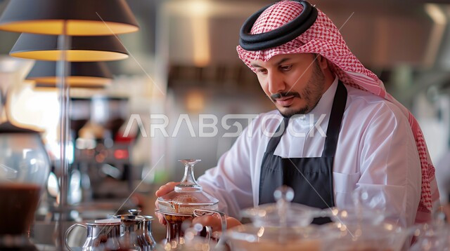 Professionalism in the profession and art of cooking, a close-up of a Saudi Arabian Gulf chef wearing a traditional costume with a shemagh and a kitchen apron standing with his hands folded in gestures of happiness and self-confidence, the art of preparing and presenting various dishes, working in the kitchens and restaurants of the Kingdom of Saudi Arabia