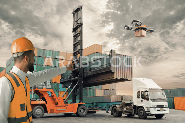A young Saudi Arabian Gulf man who supervises the work of shipping and exporting goods, truck transporting goods, delivery service, logistics and transportation, loading goods, loading goods on the trailer through a crane, a sophisticated technological pl