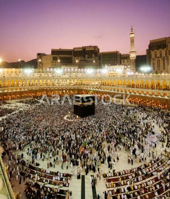 Worship and getting closer to God, a group of pilgrims in the Grand Mosque in Mecca during the day, performing the Hajj and Umrah rituals, places and landmarks of the sacred Islamic religion in the Kingdom of Saudi Arabia