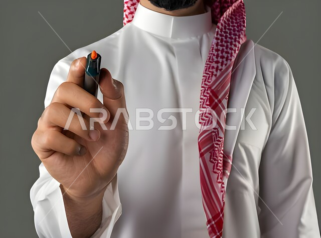 Recording and taking notes, getting ready to write and specify something, portrait of a Saudi Arabian Gulf man wearing traditional dress and a shemagh holding a pen in his hand, concept of education with prescribed curricula, white background