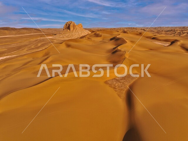 Soft golden sand and dunes in the desert of Saudi Arabia, sandy environment during the day, plateaus and hills in desert landscapes, landscapes in the deserts of the Arabian Peninsula