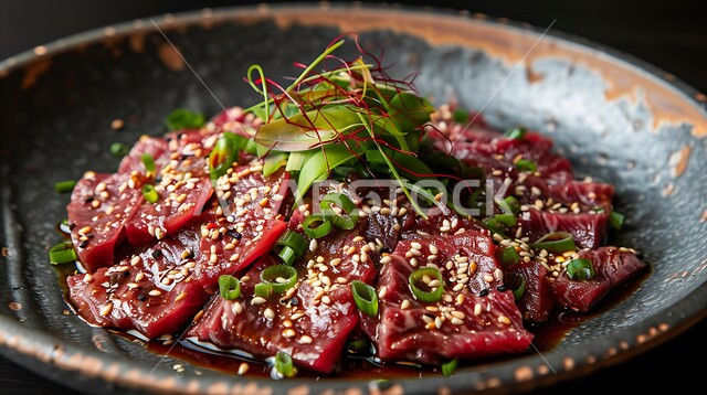 A plate of raw meat slices decorated with sesame seeds and vegetables, appetizers and delicious snacks, foods rich in proteins, restaurants and kitchens of the Kingdom of Saudi Arabia, the art of serving cold foods