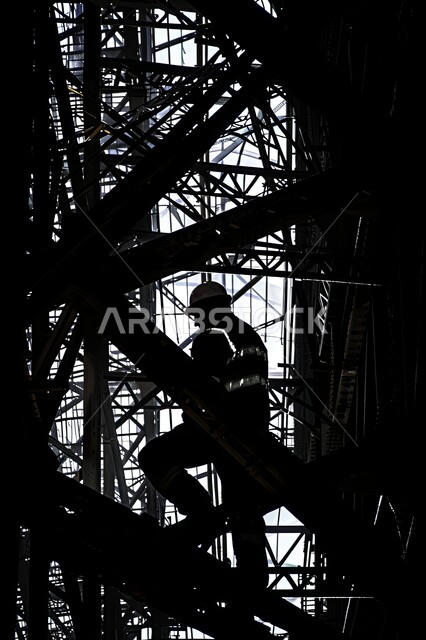 Construction, contracting and architectural development works, direct supervision of work progress, growth of the engineering sector in the Kingdom of Saudi Arabia, silhouette of a Saudi Arabian Gulf engineer wearing a protective jacket and helmet working in a building under construction, structures and foundations for buildings and residential projects, Salulit