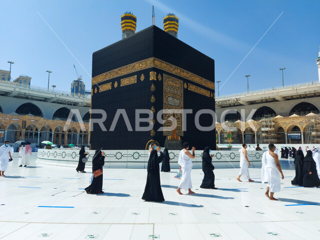 معتمرون يطوفون حول الكعبه المشرفة، مناسك العمرة في مكة المكرمة أيام انتشار فايروس كورونا في المملكة العربية السعودية، اتباع اجراءات الوقاية و السلامة من كوفيد ١٩، أماكن إسلامية دينية مقدسة, أداء العبادات والصلوات والتقرب الى الله