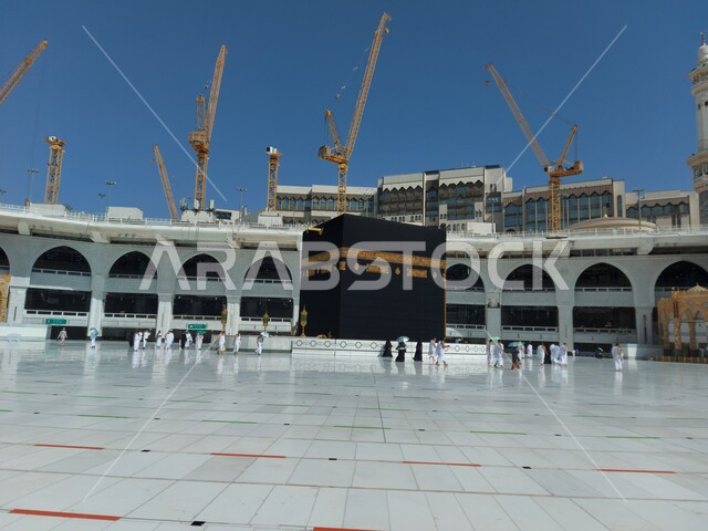 The situation of the Grand Mosque in Mecca during the days of the spread of the Corona virus in the Kingdom of Saudi Arabia, pilgrims circumambulating the Kaaba, performing the rituals of Umrah and Hajj in Mecca, following preventive and safety measures against Covid 19, sacred Islamic religious places and landmarks, performing worship and prayers and drawing closer to God