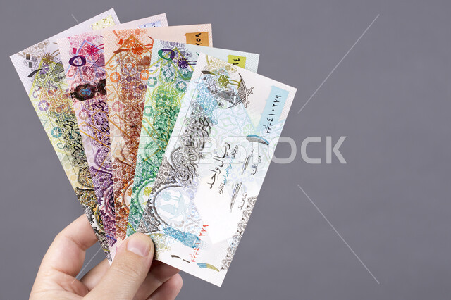A number of maritime securities, a close-up of paper money of all denominations, the official currency in circulation in buying and selling, the field of investment and finance, the Bahraini national economy, gray background