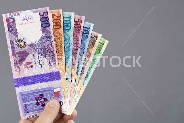 A number of maritime securities, a close-up of paper money of all denominations, the official currency in circulation in buying and selling, the field of investment and finance, the Bahraini national economy, gray background