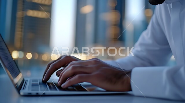 Data entry and typing through the keyboard, integrating work with technology and technology, having the skill of fast typing on the keyboard, a close-up image of the hands of a Saudi Arabian Gulf man working on a laptop, administrative office job tasks