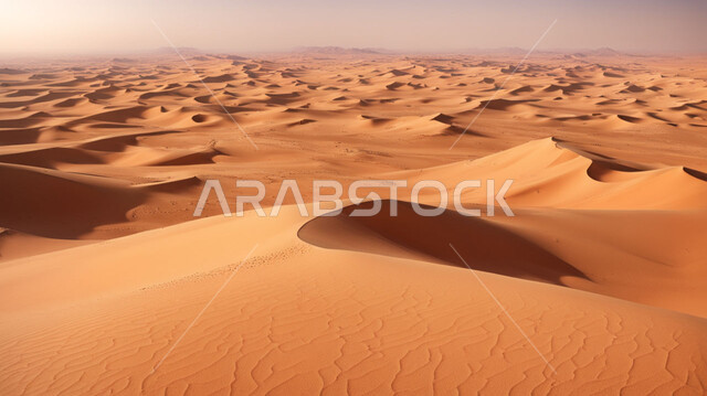 Formations and formations of golden sand in the desert of the Arabian Peninsula, terrain and dry environment in desert nature, soft sand dunes and hills formed in the Gulf deserts.