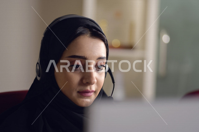 موظفة عربية خليجية سعودية تعمل في خدمة العملاء وترتدي سماعة الاتصال، استعلامات واستفسارات، الاجابه على اسئلة العملاء، اجراء اتصال فيديو من خلال الحاسوب، متابعة وتطوير العمل