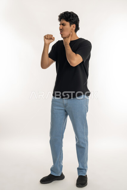 Need to go to the doctor to receive appropriate treatment, catching a cold, cough, flu and sore throat, portrait of a young Arab Gulf Emirati man in casual clothes putting his hand on his neck and coughing, gestures of illness and fatigue, full body length, white background