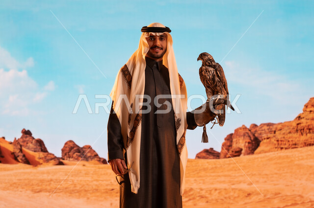 الفخر بالتراث السعودي العريق في تربية الطيور الجارحة الحرة، رمز القوة والتحدي وحدة البصر، فعاليات نادي الصقور في موسم الصيد السنوي في المملكة العربية السعودية، صورة لشاب عربي خليجي سعودي يقوم بترويض طائر الصقر في المحميات الطبيعة