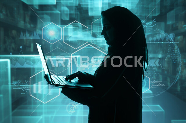 Digital transformation concept, integration of advanced technology with work, use of modern technologies, side view of a veiled Saudi Arabian Gulf woman holding a laptop in her hand standing in front of illuminated 3D holographic icons and shapes, technological future vision