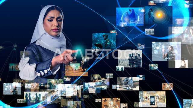 تعزيز مفهوم التطور الرقمي والتكنولوجي في المجتمع السعودي، استخدام التقنيات الحديثة، صورة مقربة لإمرأة عربية خليجية سعودية محجبة ترتدي العباءة تقوم بالنقر على الايقونات والشرائح المضيئة بإيماءات الانزعاج، التفاعل والاندماج مع العناصر الهولوجرامية