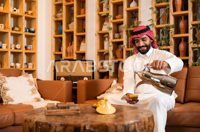 Authentic customs and traditions in serving drinks, following the approach of the ancestors in honoring the guest, a close-up image of a Saudi Arabian Gulf man wearing the traditional dress and shemagh pouring coffee from a copper pot, inheriting good reception and generosity, offering local products to guests