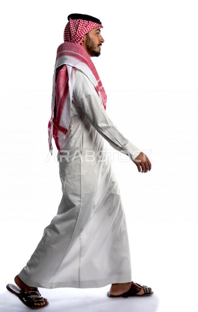 بورتريه لرجل عربي سعودي خليجي يقوم بجلسة تصوير بإيماءات وجه ويدين مختلفة ، منظر جانبي لرجل سعودي مسلم يرتدي زي تقليدي سعودي مع شماغ وعقال ، خلفية بيضاء