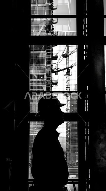 Auditing and supervision in industrial laboratories, factories of the Kingdom of Saudi Arabia, working in the industrial field, jobs and professions for youth in the Kingdom of Saudi Arabia, silhouette of a Saudi Arabian Gulf engineer wearing a jacket and a protective helmet walking around the factory, Saluit