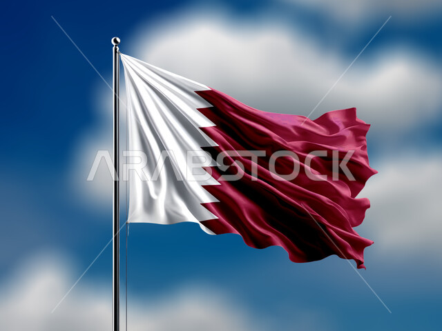 The flag of the State of Qatar flutters in the country's sky, pride, honor, love of the homeland and belonging to it, celebrating holidays and occasions, remembering history and national identity, the memory of Qatar National Day, December 18, a view of the blue sky filled with clouds