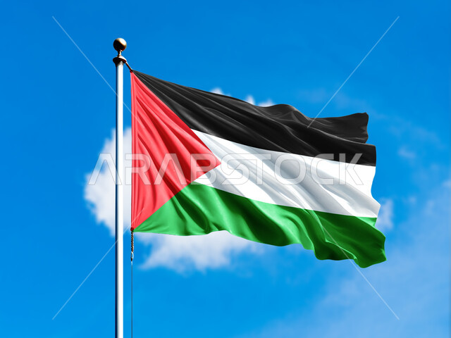 Remembrance of the celebration of the Palestinian National Day, November 15, the day we began in 1988 AD, love of the homeland and belonging to it, the flag of the Palestinian state fluttering in the sky of the homeland, participation in national holidays and occasions, Arab symbols and banners, background of the blue sky filled with clouds