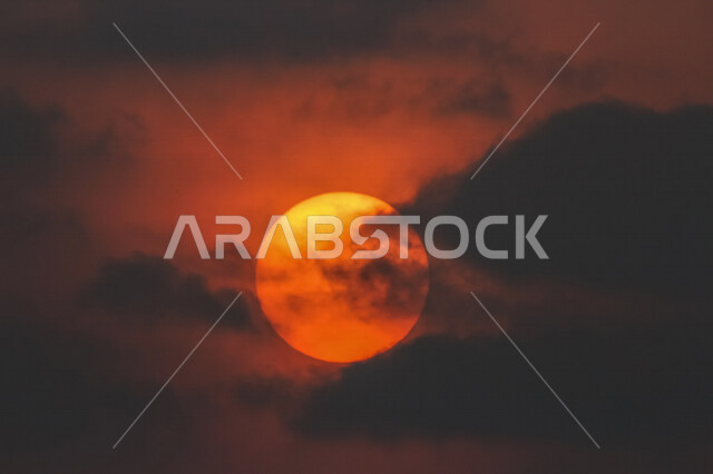 Sun silhouette, beautiful sunset landscape, beauty of the sun covered with clouds, beauty of nature