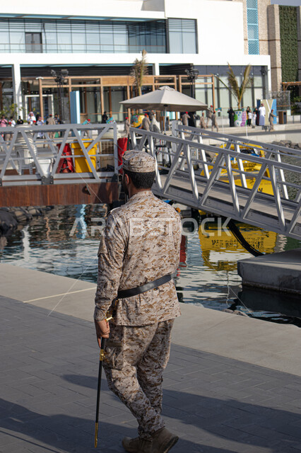 Watchful eyes to provide security and safety, the military forces in the Kingdom of Saudi Arabia, a parade of a Saudi Gulf Arab soldier from the naval forces wearing a special military uniform walking with a straight back and presenting a distinctive show, protecting the homeland and defending the borders on land, sea and air