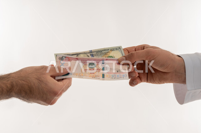 Cash payment concept, process of paying money with dirhams, receiving and delivering deposits, currency in circulation in the UAE markets, financial economic business, close-up portrait of an Arab Gulf Emirati man wearing a kandura paying bills and purchase accounts, white background