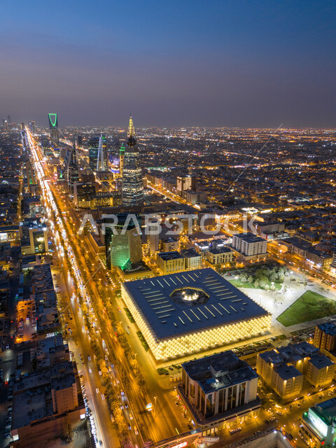 Famous tourist attractions in Riyadh, exterior architectural art of towers and skyscrapers, aerial view of the illuminated King Fahd Library in the capital, national libraries in Saudi Arabia, traffic movement on the public road