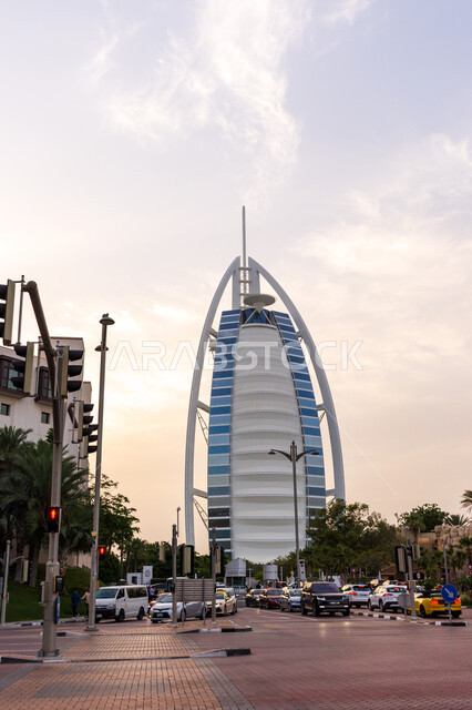 Modern architectural engineering art of towers and skyscrapers, Burj Al Arab Hotel in Dubai, attracting and attracting tourists from all over the world, traffic in the streets, interest in afforestation and planting green plants, tourist facade in the Emirates, famous tourist attractions