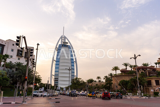 Modern architectural engineering art of towers and skyscrapers, Burj Al Arab Hotel in Dubai, attracting and attracting tourists from all over the world, traffic in the streets, interest in afforestation and planting green plants, tourist facade in the Emirates, famous tourist attractions
