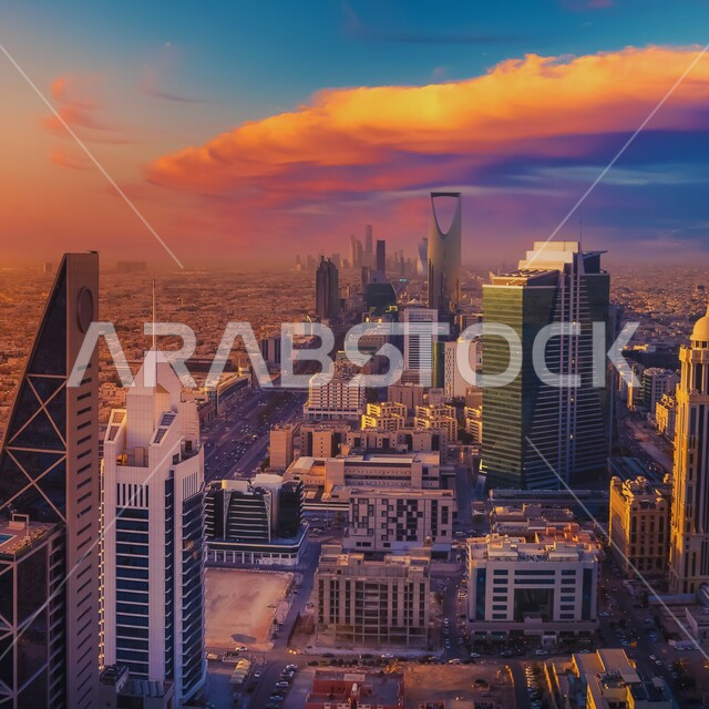 الأبراج وناطحات السحاب المشهورة في مدينة الرياض، الفن الهندسي المعماري للمنشآت السكنية والتجارية على الطراز الحديث، منظر السماء المليئة بالغيوم وقت غروب الشمس