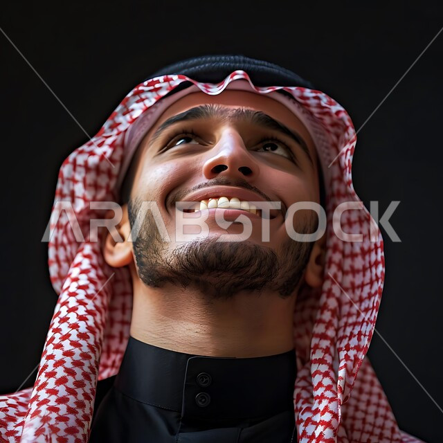 The concept of contemplation and planning for the future, manliness, elegance and interest in appearance, close-up portrait of a smiling Saudi Arabian Gulf man wearing traditional thobe and shemagh looking up with cheerful expressions, focusing on something with gestures of pleasure and happiness, background
