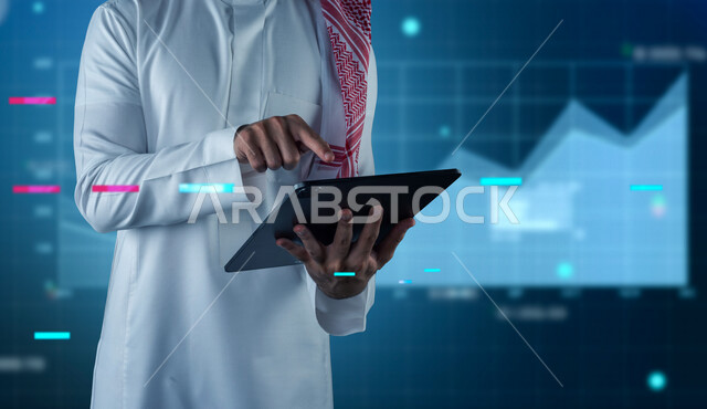 صورة مقربة لرجل عربي خليجي سعودي في مقر عمله بالشركة، يتابع البورصة من خلال استخدام التابليت، صعود ونزول البورصة المالية، الاستثمار المالي والاقتصادي، أعمال الكترونية تجارية