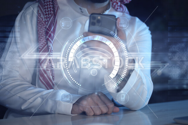 صورة مقربة لرجل عربي خليجي سعودي يستخدم هاتفه المحمول، مجموعة من الأيقونات المتطايرة المضيئة الخاصة بشبكة الواي فاي بتقنية الهولوجرام ثلاثية الأبعاد، تقنيات متطورة
