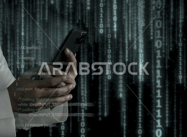 صورة يد شاب سعودي خليجي يعمل في وظيفة مطور ويب، استخدام لغات البرمجة، تطوير وبناء المواقع والتطبيقات الالكترونية، اكواد برمجية لبناء تطبيقات الهواتف الذكية