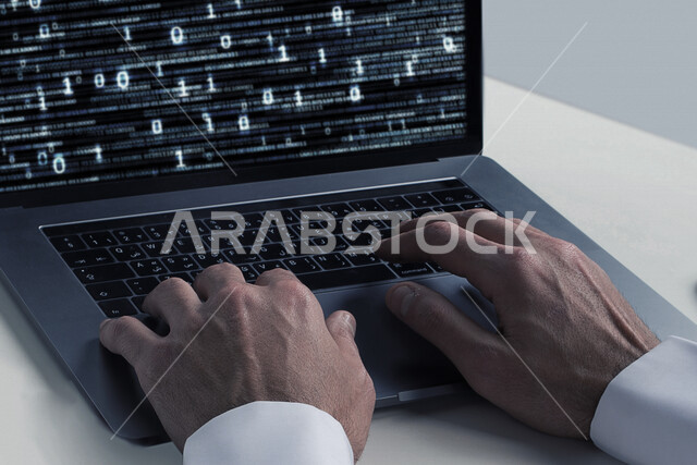 A young Saudi Gulf working as a web developer, using programming languages, developing and building websites and electronic applications, codes and algorithms, and computer technologies