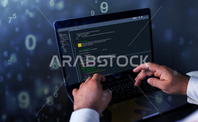 A young Saudi Gulf working as a web developer, using programming languages, developing and building websites and electronic applications, codes and algorithms, and computer technologies